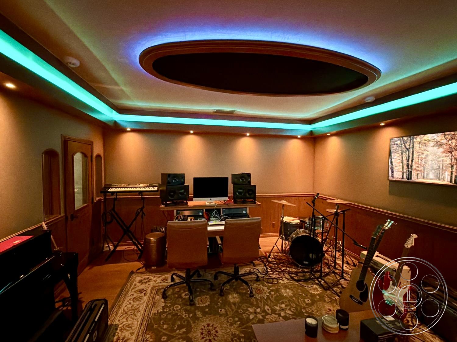 Medit 167 - wall-mounted artwork, vintage area rug, dark wood paneling walls, LED recessed lighting, exposed ductwork details, acoustic ceiling treatment, modern desk workspace, interior music studio, vinyl studio flooring, integrated sound system setup, round coffered ceiling, guitar and drum set placement, piano corner setup
