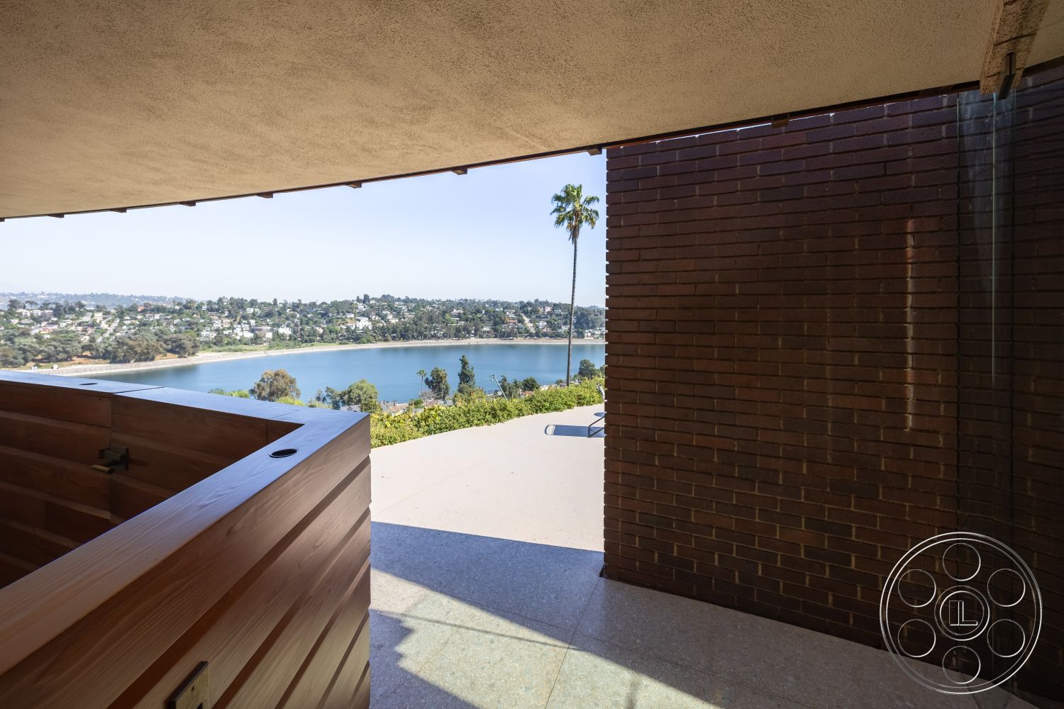 Silvertop House - exterior, landscaped garden, modern design, open floor plan, glass sliding doors, surrounding greenery, brick wall, city skyline view, clear sightlines, minimalist architecture, wooden hot tub, natural light emphasis, exposed aggregate concrete patio floor, cantilevered roof, lakefront property