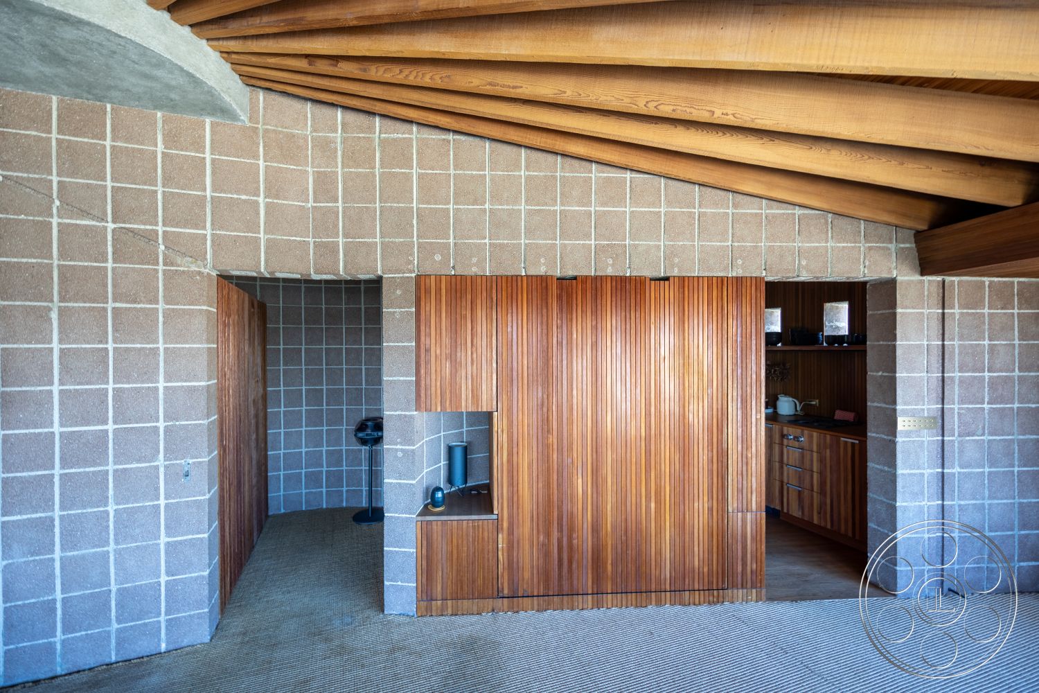 Silvertop House - interior open kitchen layout, interior exposed wood ceiling beams, interior subtle color palette, interior recessed lighting fixtures, interior minimalist design elements, interior natural light through large windows, interior warm wood tones, interior seamless indoor-outdoor flow, interior contemporary architectural style, interior concrete block walls, interior textured carpet flooring, interior wooden slatted cabinets, interior cozy living space, interior integrated cabinetry