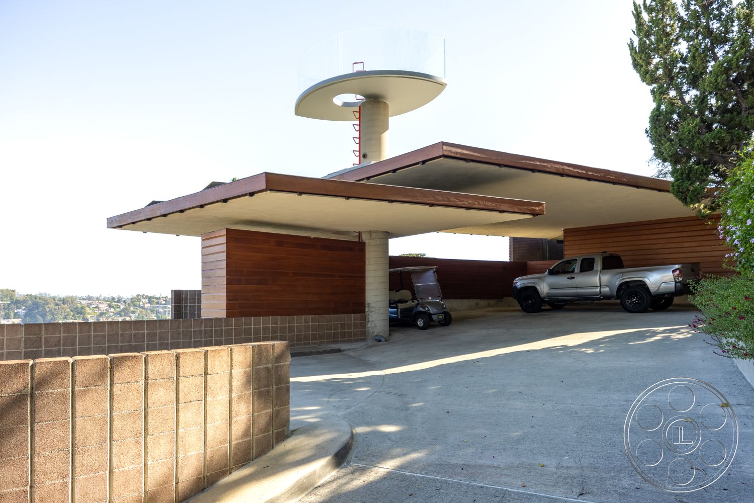 Silvertop House - outdoor landscaping, floor-to-ceiling windows, modern architectural style, city skyline view, open-air patio, cinder block wall, minimalist exterior, flat concrete driveway, wood panel siding, exterior carport structure, overhanging roof design, attached carport roof, sloping driveway, stylish architectural details