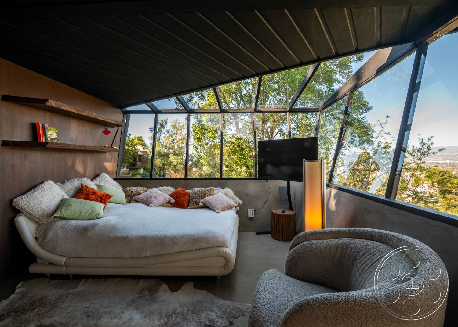 Retro 31 - minimalist decor, concrete flooring, open concept design, concrete walls, sustainable materials, indoor greenery, contemporary aesthetic, stylish accent pillows, curved lounge chair, exposed wood ceiling beams, glass wall panels, wooden floating shelves, integrated entertainment system, soft textured rug, rounded modern bed, surrounding natural landscape view, accessible natural light