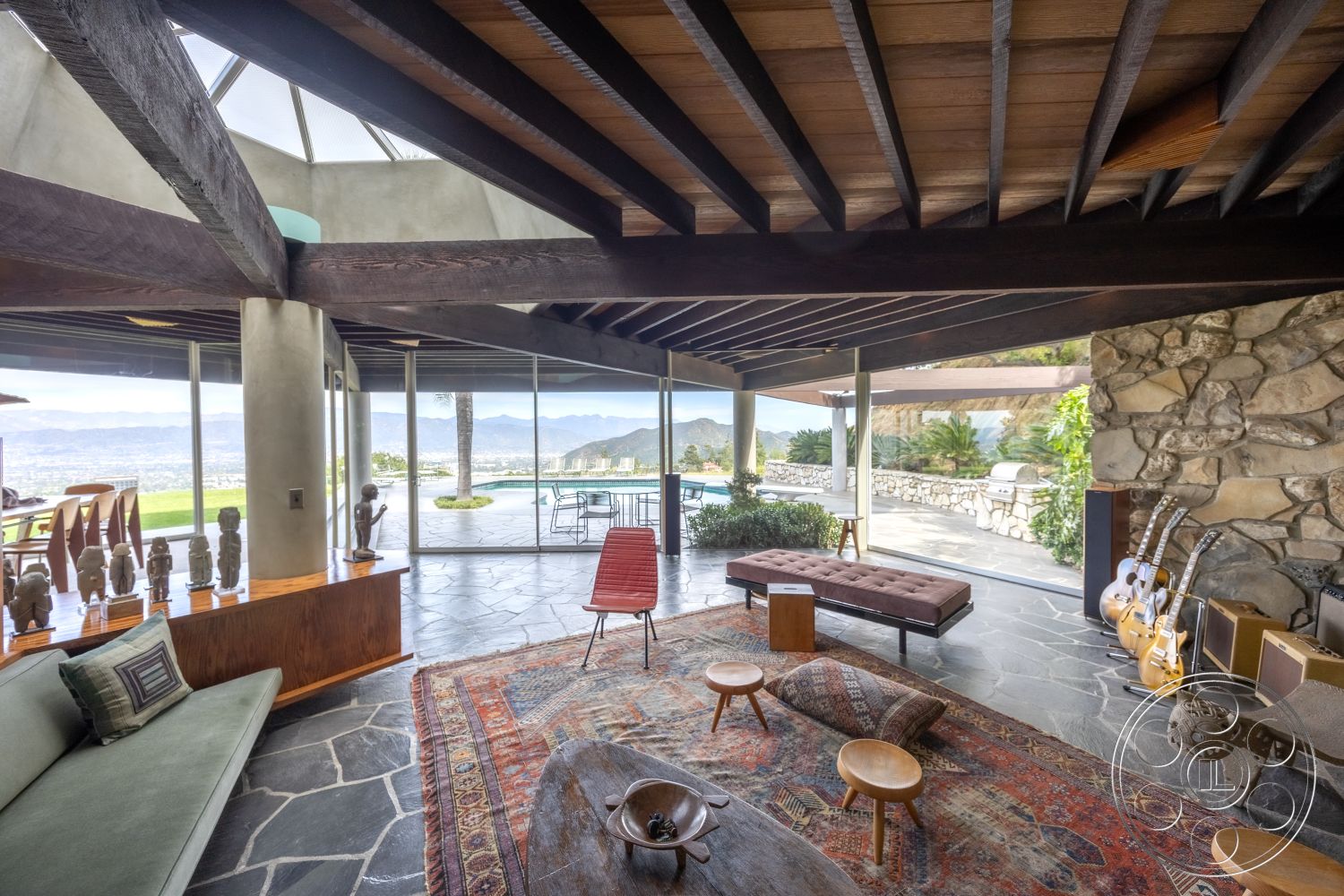 Retro 19 - glass sliding doors interior, exposed wood ceiling beams interior, wood beam ceiling interior, natural light filled space interior, open concept living space interior, stone feature wall interior, floor-to-ceiling glass windows interior, exterior stone wall, modern sectional sofa interior, mountain view setting exterior, wood accent furniture interior, slate stone flooring interior, contemporary area rug interior, mid-century modern accent chairs interior, lap pool exterior, polished concrete columns exterior, garden patio exterior, circular dining table interior, artistic wood sculptures interior, tropical landscaping exterior