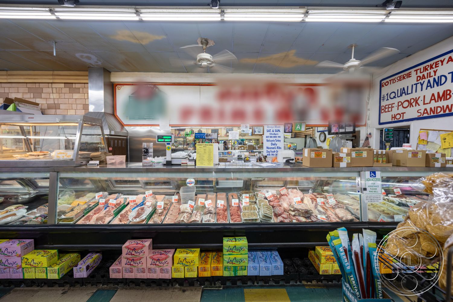 Shop 128 - tile flooring, exposed ceiling, glass display cases, wood paneling walls, fluorescent ceiling lights, metal counter, checkered tile pattern, merchandise boxes, colorful packaging, meat display section, butcher shop environment, cooling units, menu signs, customer service area
