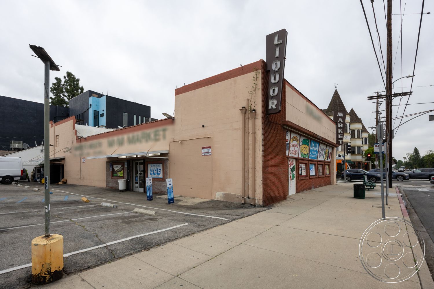 Shop 128 - exterior, flat roof, city street view, vintage signage, concrete sidewalk, stucco wall finish, surrounding urban environment, brick commercial building, storefront windows with awnings, parking lot surface, adjacent multi-story buildings, intersection setting