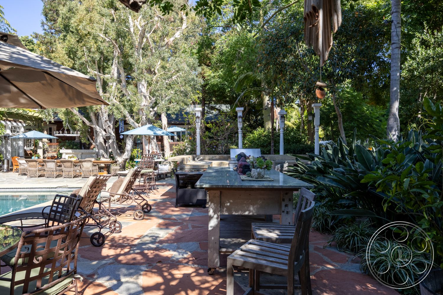 Americana 48 - exterior, rectangular pool, outdoor lighting fixtures, surrounding lush greenery, stone patio flooring, wooden outdoor dining table, stainless steel barbecue grill, wrought iron patio chairs, canvas umbrellas, stone garden paths, natural wood posts