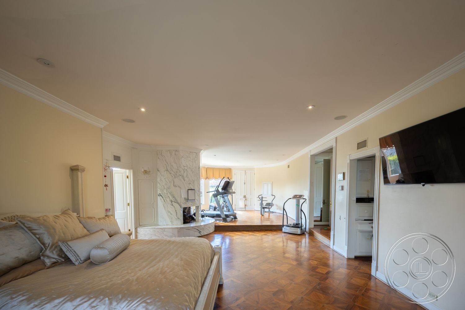 Mansion 146 - open floor plan, floor-to-ceiling windows, contemporary design elements, textured ceiling, marble feature wall, built-in cabinetry, recessed lighting fixtures, dark hardwood bedroom floors, white painted walls, decorative crown molding details, modern fitness area, studio space layout