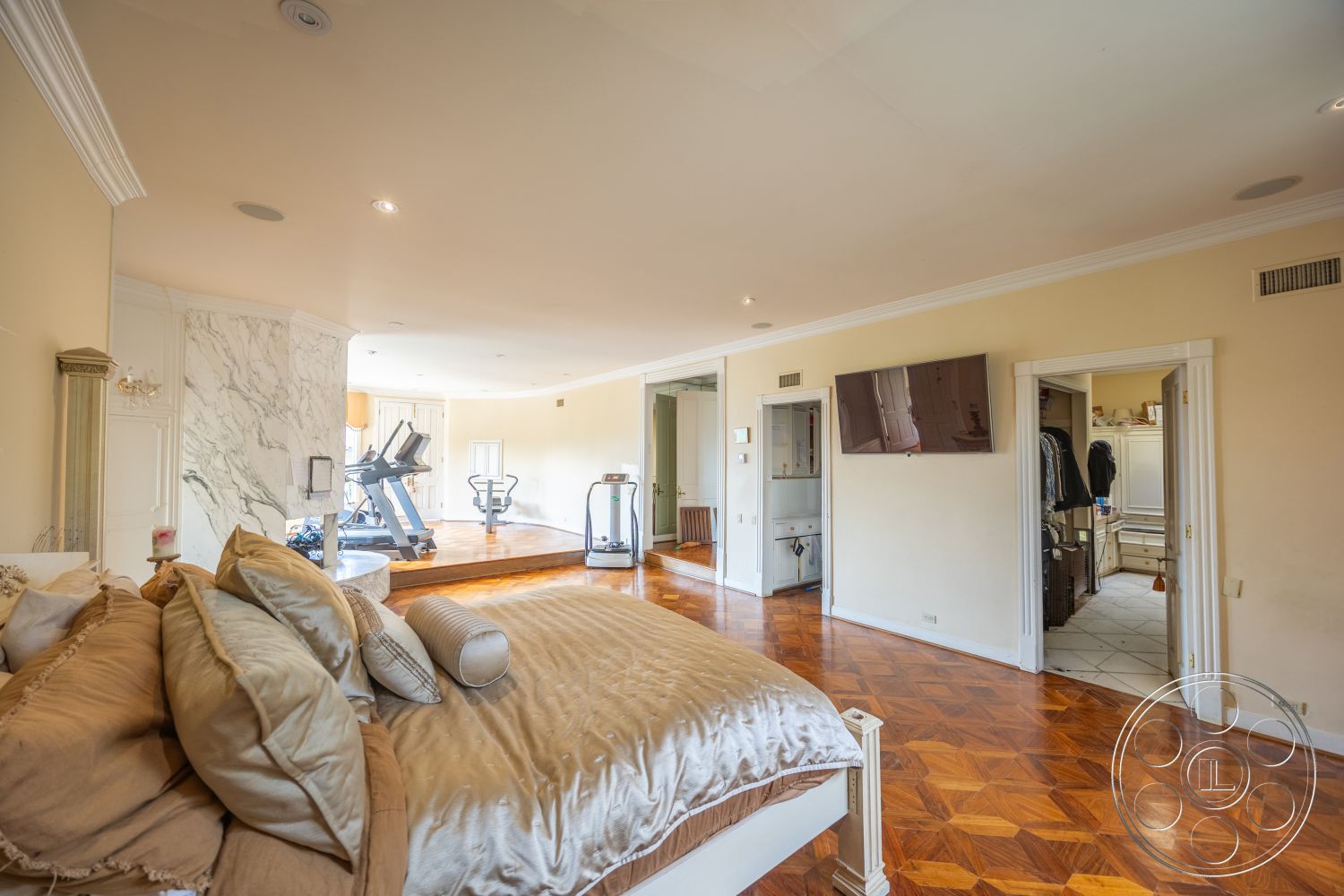 Mansion 146 - plush bedding, floor-to-ceiling windows, textured throw pillows, decorative crown molding, marble accent wall, contemporary lighting fixtures, hardwood bedroom floors, built-in closet, gym area