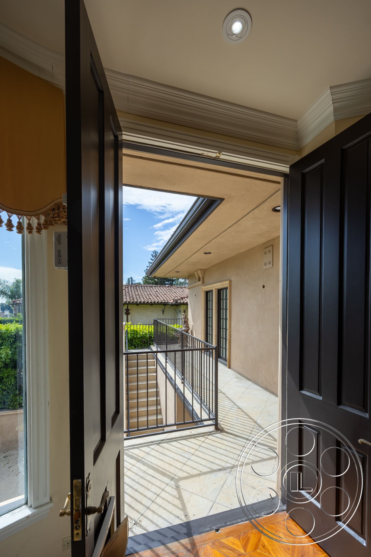 Mansion 146 - exterior, landscaped garden view, metal railing, floor-to-ceiling windows, decorative crown molding, modern architectural style, textured plaster walls, outdoor staircase, luxury home entrance, stone patio flooring, natural light entry, black double front doors, overhang ceiling feature