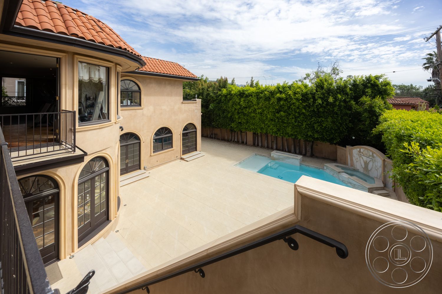 Mansion 146 - natural light, exterior, rectangular swimming pool, concrete steps, terracotta roof tiles, plastered walls, arched windows, metal balcony railings, landscaped garden area, stone patio flooring, sunlit outdoor space, curved exterior wall, lush green hedge