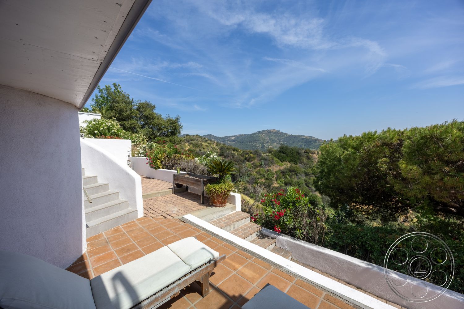 Retro 288 - exterior, outdoor lounge area, plaster wall, landscaped garden setting, elevated hillside location, concrete staircase, terracotta tile patio flooring, planting beds with greenery