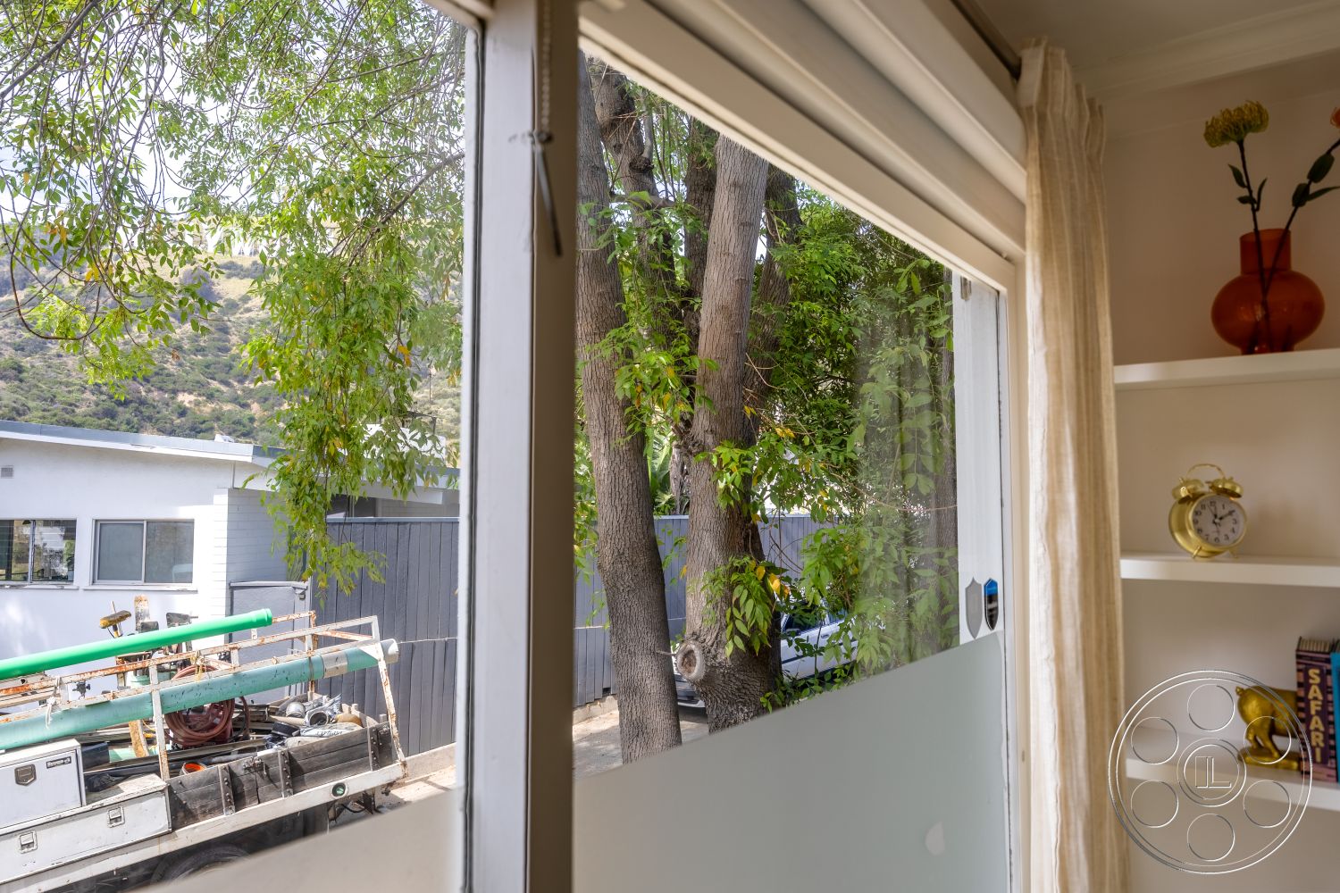 Retro 288 - neutral color palette, natural light, modern architecture, curtains, exterior view, mountain view, glass window, green trees, shelf decor, gray exterior walls