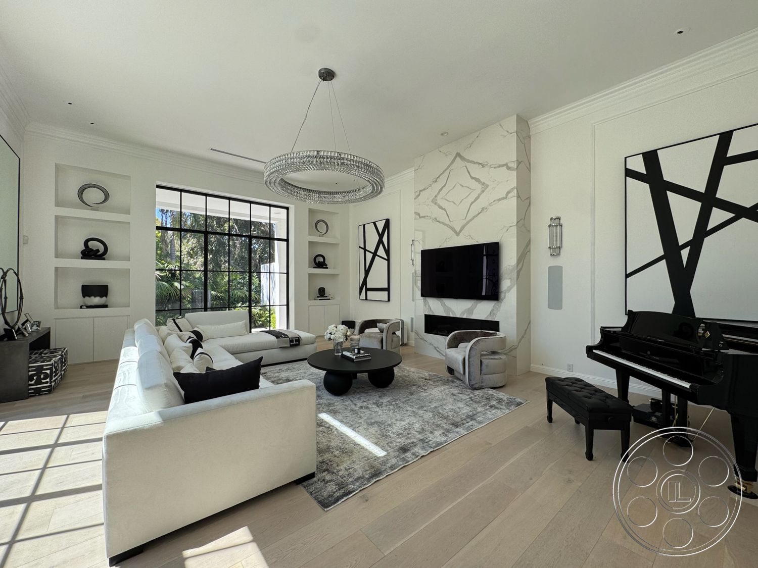 Modern 522 - round coffee table, light hardwood flooring, open shelving, modern aesthetic, floor-to-ceiling windows, black grand piano, black accent pillows, marble feature wall, glass chandelier, area rug with geometric pattern, white painted walls, white fabric sectional sofa, artwork with abstract designs