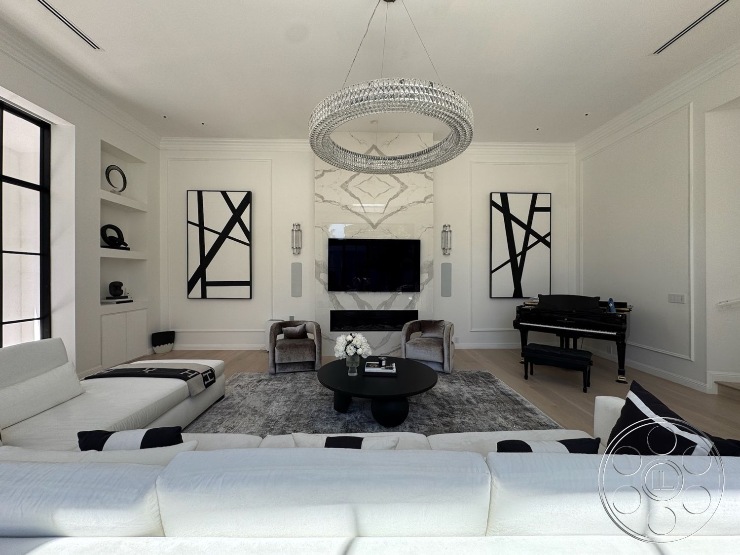 Modern 522 - neutral color palette, hardwood flooring, minimalist design, textured area rug, abstract wall art, built-in shelving, natural light from large windows, white sectional sofa, marble feature wall, flat-screen television, glass chandelier, modern living room, round black coffee table, black and white throw pillows, transparent wall sconces, piano with polished finish