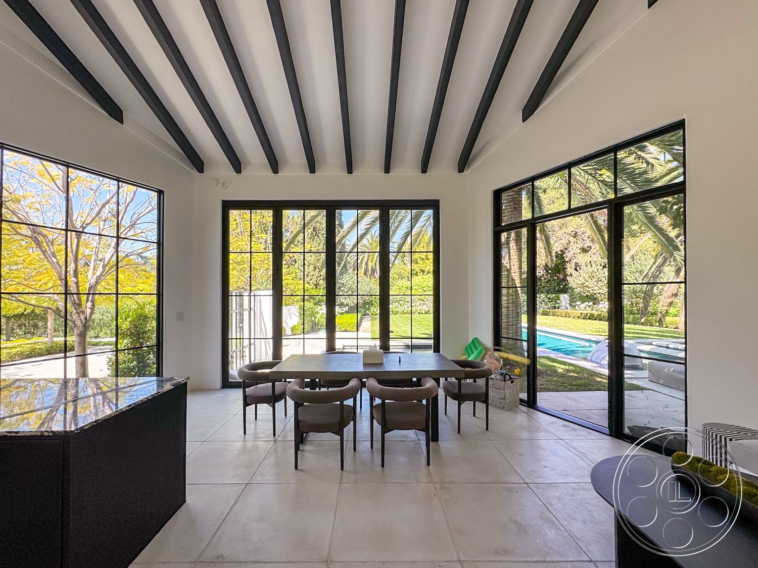 Modern 522 - floor-to-ceiling windows, black dining table, modern dining area, exposed wood ceiling beams, granite kitchen countertop, concrete floor tiles, curved dining chairs