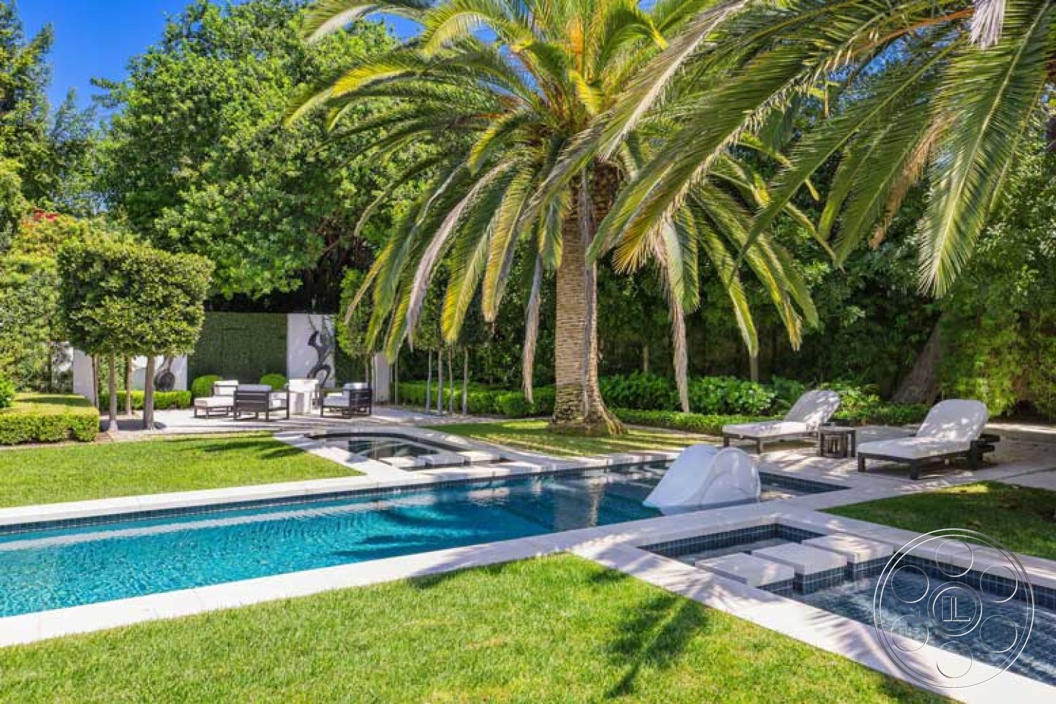 Modern 522 - exterior, palm trees, grass lawn, lap pool, wooden lounge chairs, hedge landscaping, landscaped garden area, concrete pool border, sunlit outdoor space, rectangular patio, tile pool waterline, tropical garden setting, white poolside lounge chairs, stone paved patio