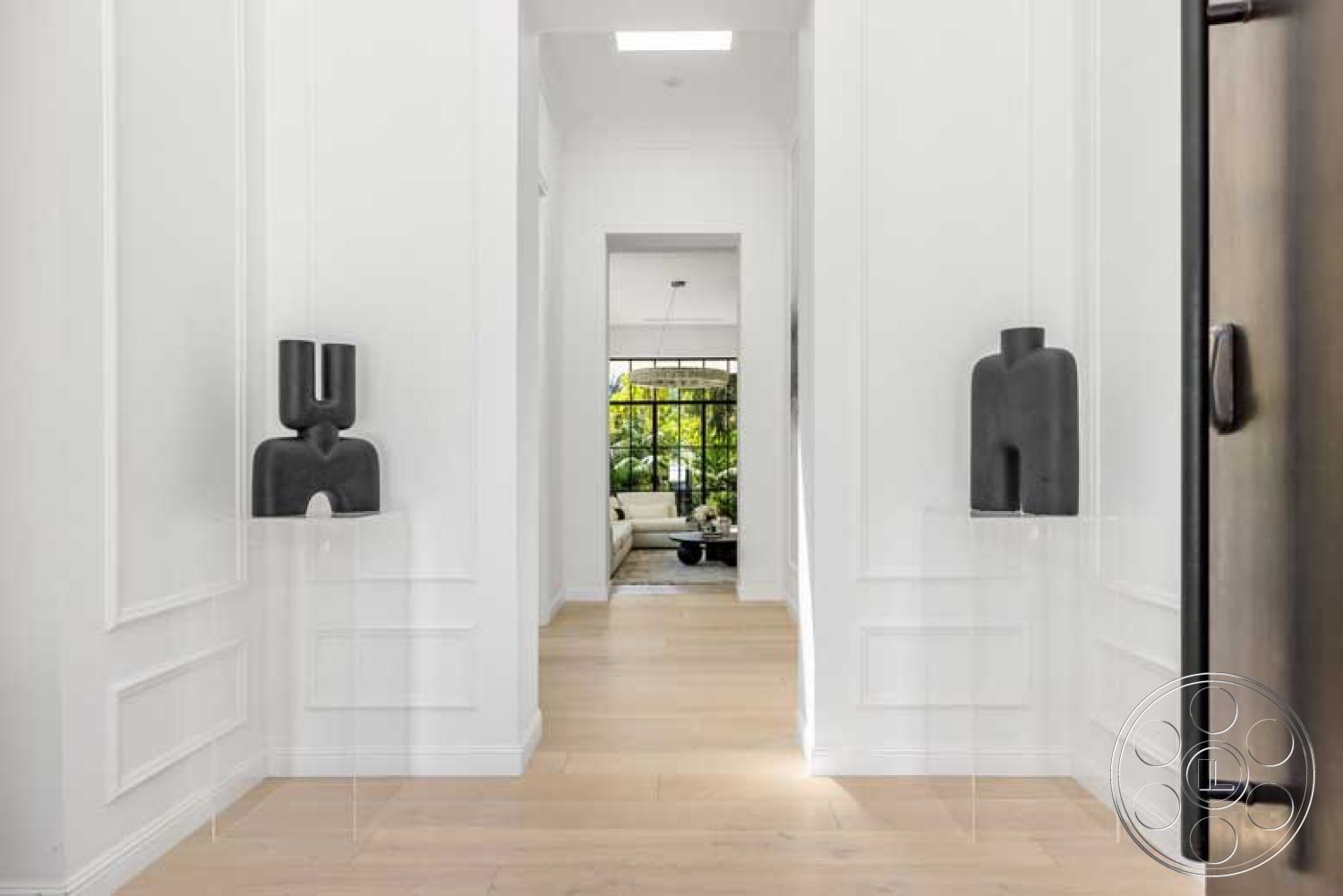 Modern 522 - minimalist design, floor-to-ceiling windows, modern architectural style, skylight, arched doorway, open living area, light hardwood plank flooring, white paneled walls, black sculptural wall art, contemporary hallway