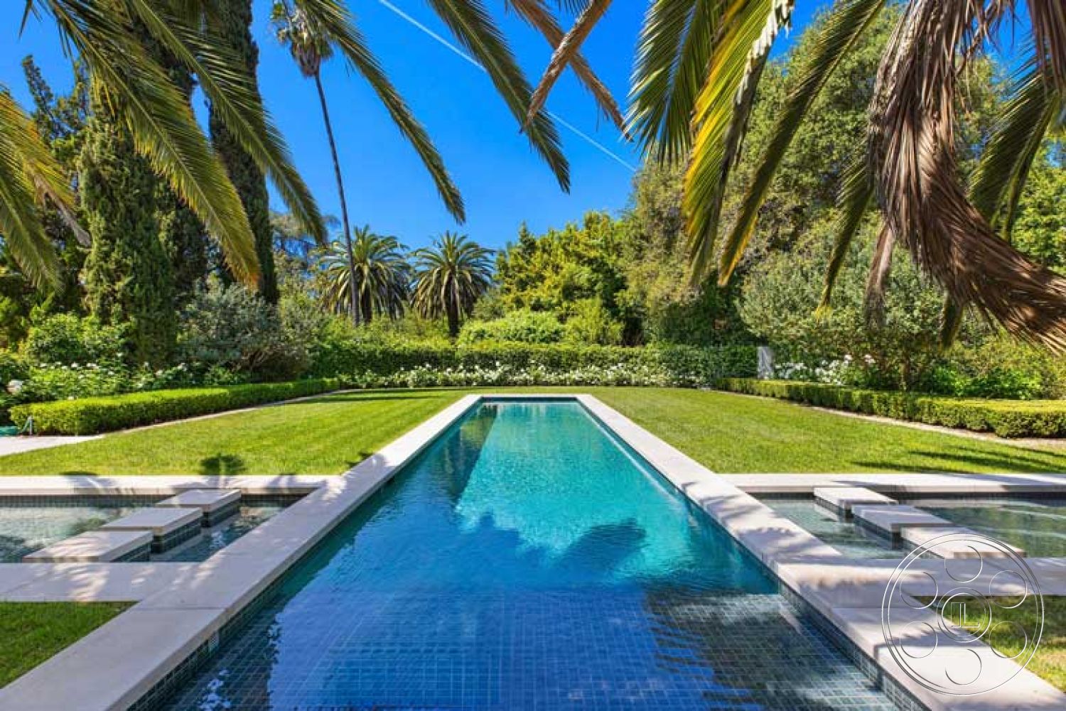 Modern 522 - exterior, landscaped garden, tropical palm trees, rectangular pool, sunny outdoor setting, concrete pool border, glass tile pool water surface, lawn grass, hedge garden border