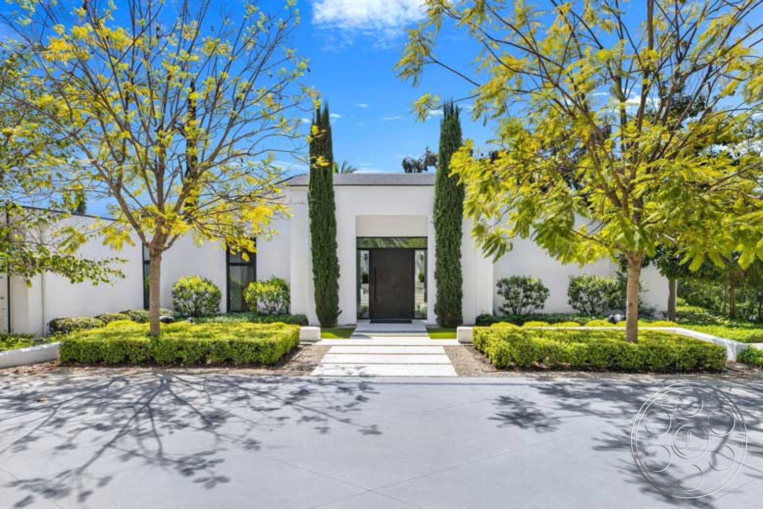 Modern 522 - exterior, landscaped garden, flat roof, clear sky, concrete driveway, stucco walls, cypress trees, pedestrian pathway, paver stones, hedge border, minimalist architectural style, rectangular steps, sunlight casting shadows, modern front entryway