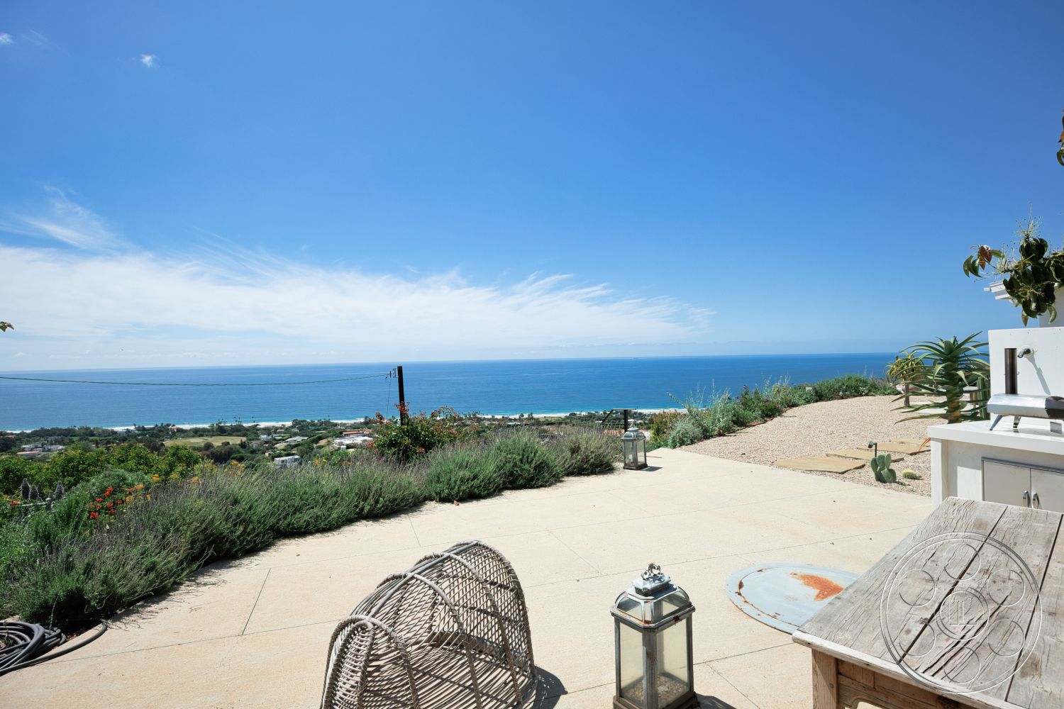 Modern 523 - landscaped garden, contemporary outdoor furniture, ocean view, open-air living space, sunny exterior, stone patio flooring, coastal outdoor setting
