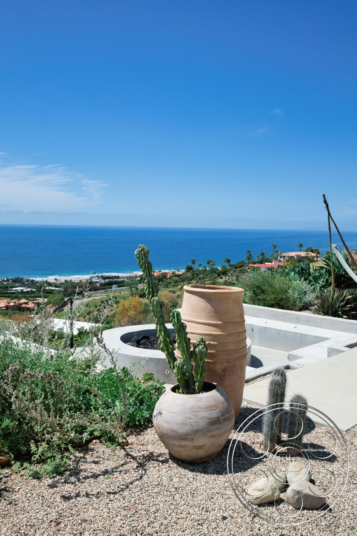 Modern 523 - exterior, natural stone accents, ocean view, desert landscaping, concrete planter, modern outdoor space, succulent garden, sunny environment, ceramic urn with cactus, gravel patio