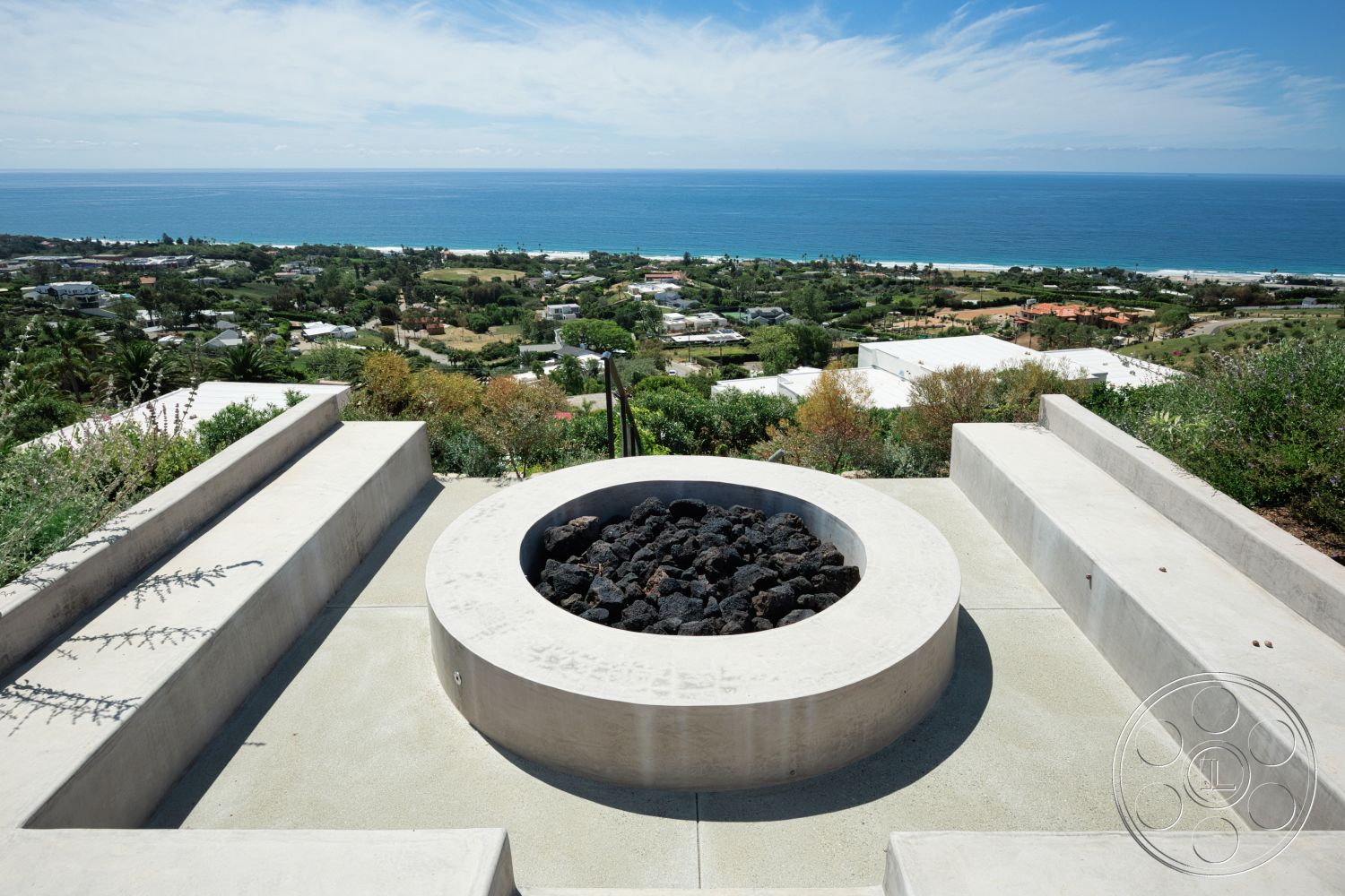Modern 523 - exterior, concrete steps, modern outdoor space, concrete fire pit, landscaped hillside garden, rectangular seating area, textured concrete patio floor, concrete seating walls, view of ocean