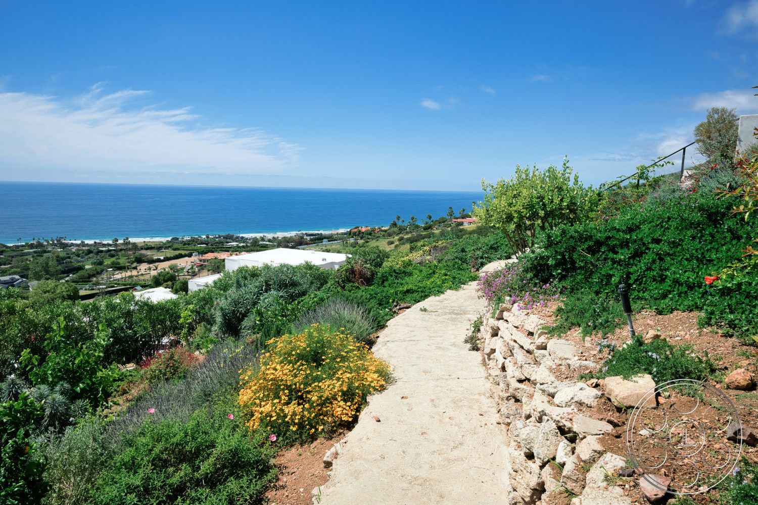 Modern 523 - exterior, ocean view, concrete path, hillside location, tropical vegetation, colorful flower beds, lush green landscaping, suburban garden, stone garden retaining wall