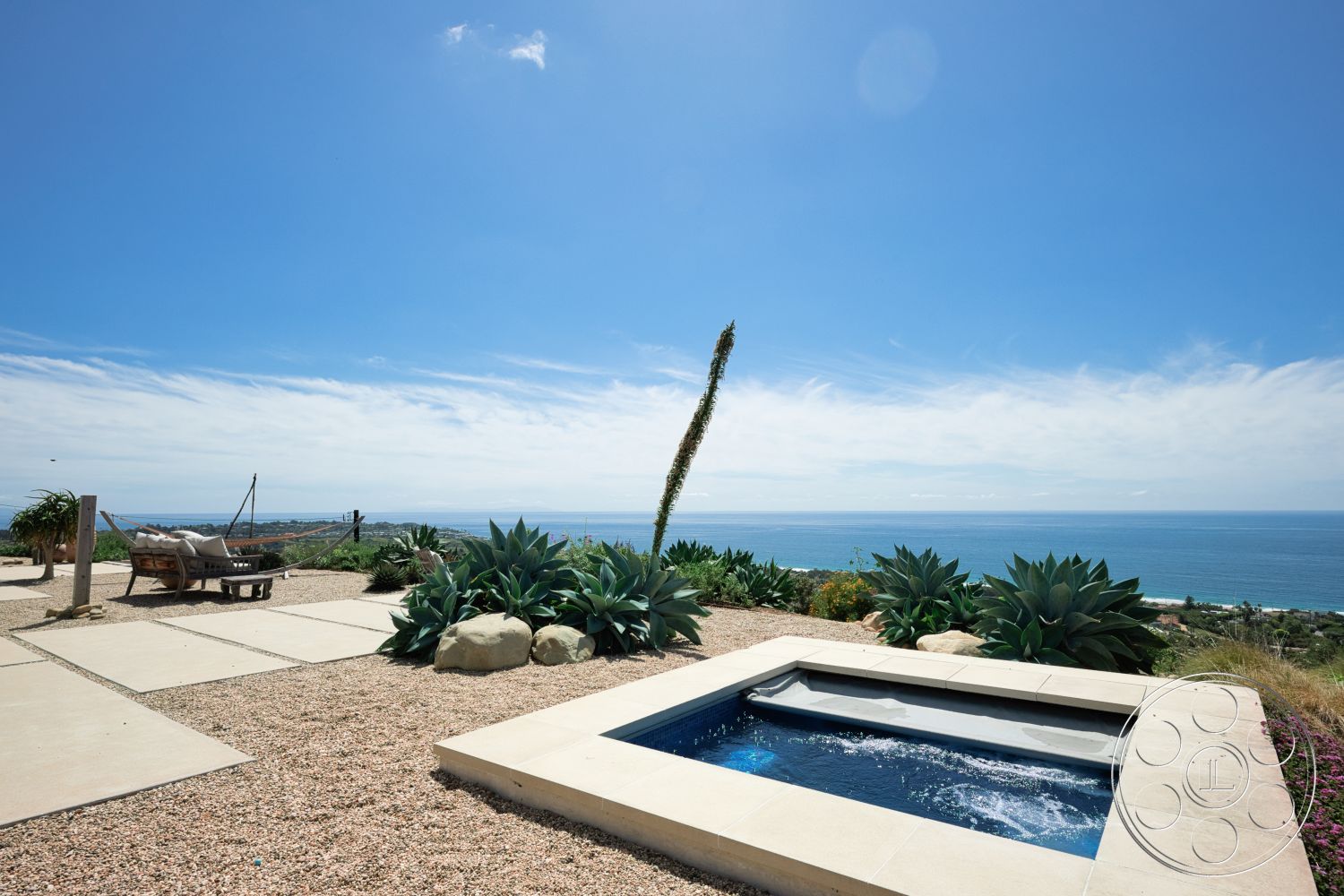 Modern 523 - exterior, potted plants, outdoor seating, gravel landscaping, ocean view, clear blue sky, sunbathing area, desert plants, concrete patio floor, rectangular spa