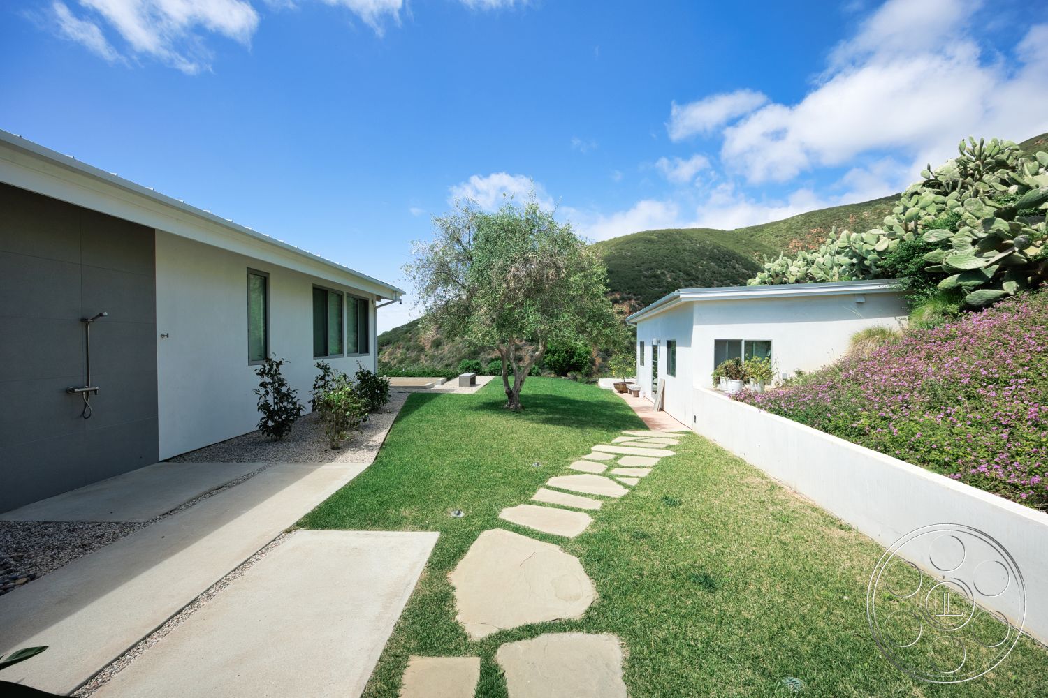 Modern 523 - large windows, exterior, landscaped garden, concrete pathway, grass lawn, stucco walls, flat roof design, stepping stone walkway, modern minimalist architecture, desert plants landscaping, desert mountain view