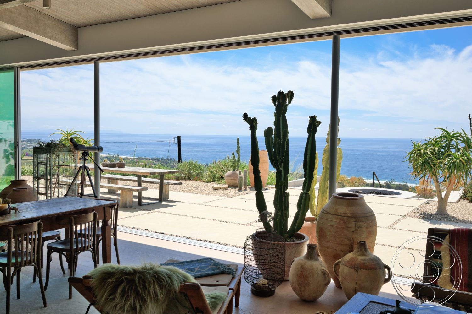 Modern 523 - landscaped garden, wood dining table, glass sliding doors, wooden chairs, ocean view, desert landscape, ceramic pots, exposed concrete ceiling, concrete patio flooring, modern minimalist design, potted cacti