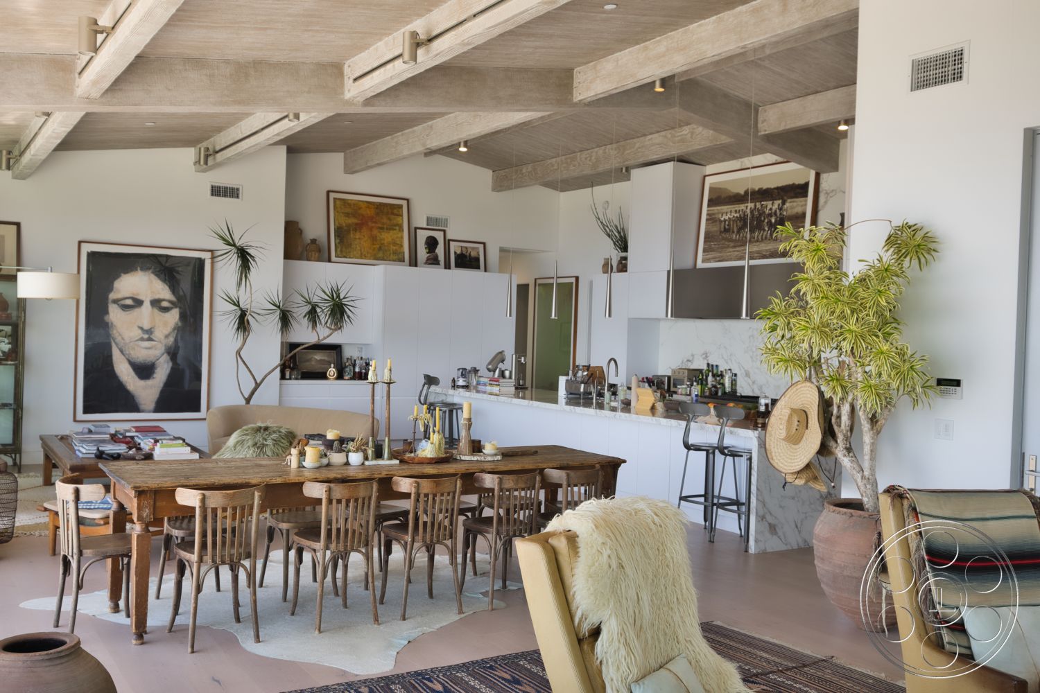 Modern 523 - neutral color palette, polished concrete floor, open floor plan, textured throw blanket, stylish bar stools, oak dining table, large wall art, wooden accent tables, wooden dining chairs, rug with geometric pattern, pendant lighting fixtures, marble kitchen island countertop, potted indoor plants, contemporary art wall decor, exposed concrete ceiling beams, white kitchen cabinetry, minimalist kitchen appliances