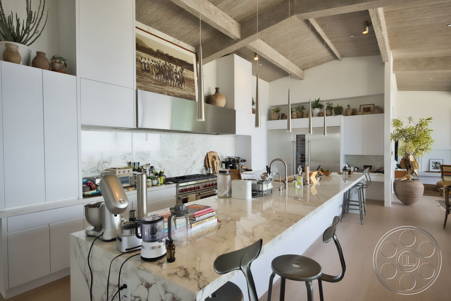 Modern 523 - modern kitchen, large windows, minimalist design, open floor plan, stainless steel appliances, kitchen island, textured wall finish, white cabinetry, marble countertop, hardwood floor, decorative potted plants, exposed wood ceiling beams, artwork wall display, pendant light fixtures