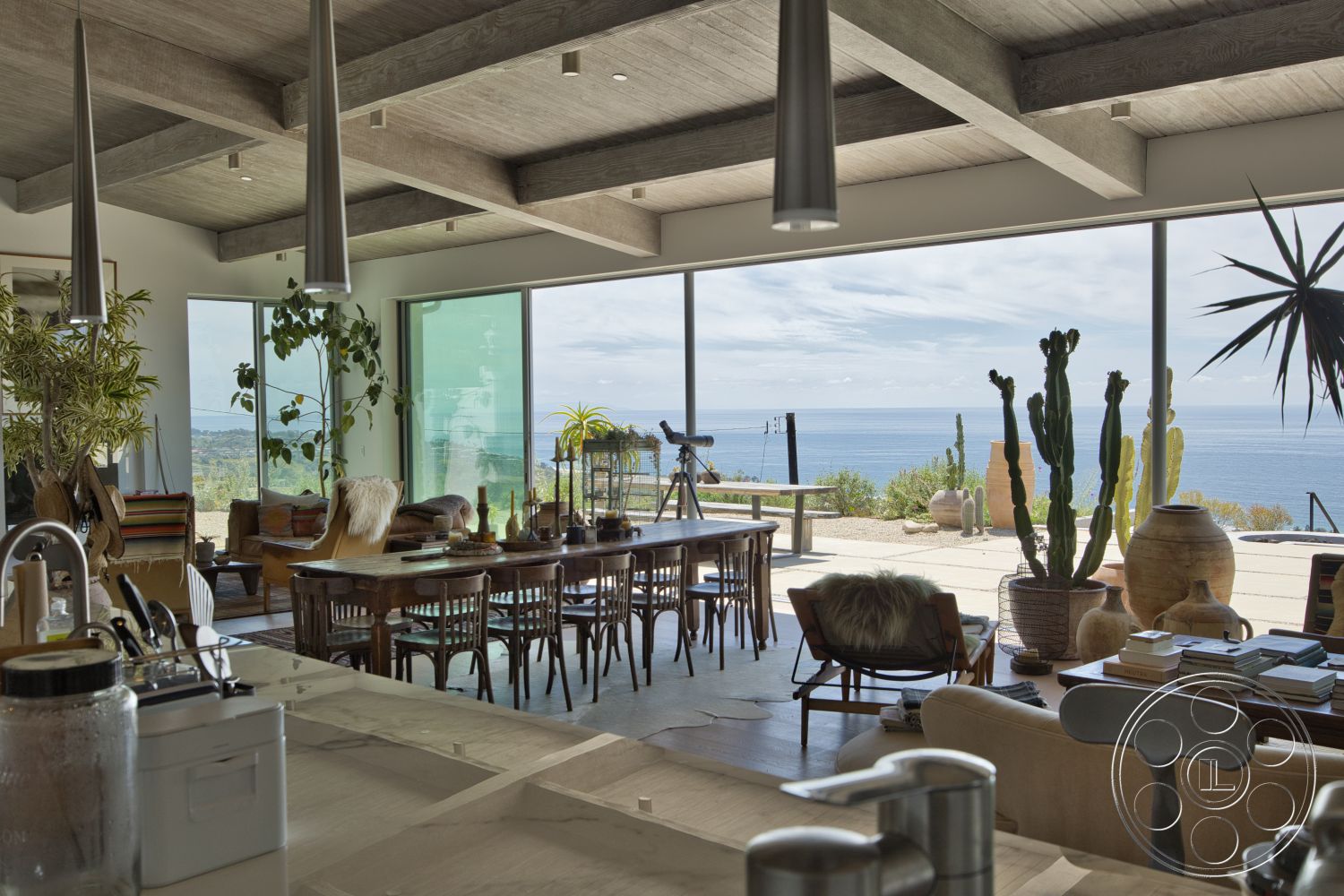 Modern 523 - minimalist decor, natural light, tile flooring, living area, ocean view, dining space, cactus garden, contemporary lighting fixtures, floor-to-ceiling glass windows, potted indoor plants, open-concept interior, hardwood dining table, exposed concrete ceiling beams