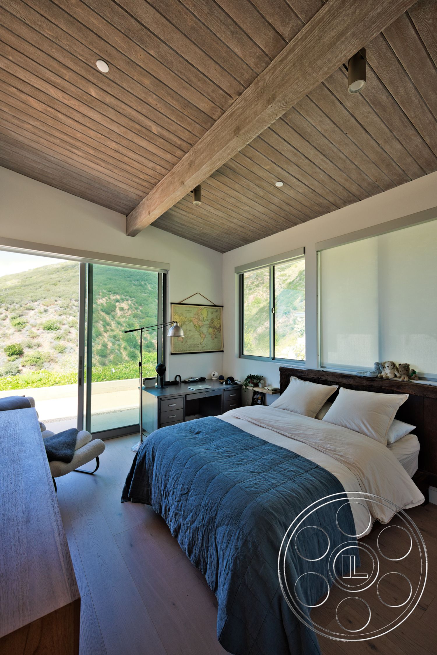 Modern 523 - natural light, open floor plan, textured bedding, floor-to-ceiling windows, mountain view setting, exposed wood ceiling beams, hardwood bedroom floors, contemporary bedroom decor, vaulted ceiling interior, modern wooden furniture, minimalistic workspace
