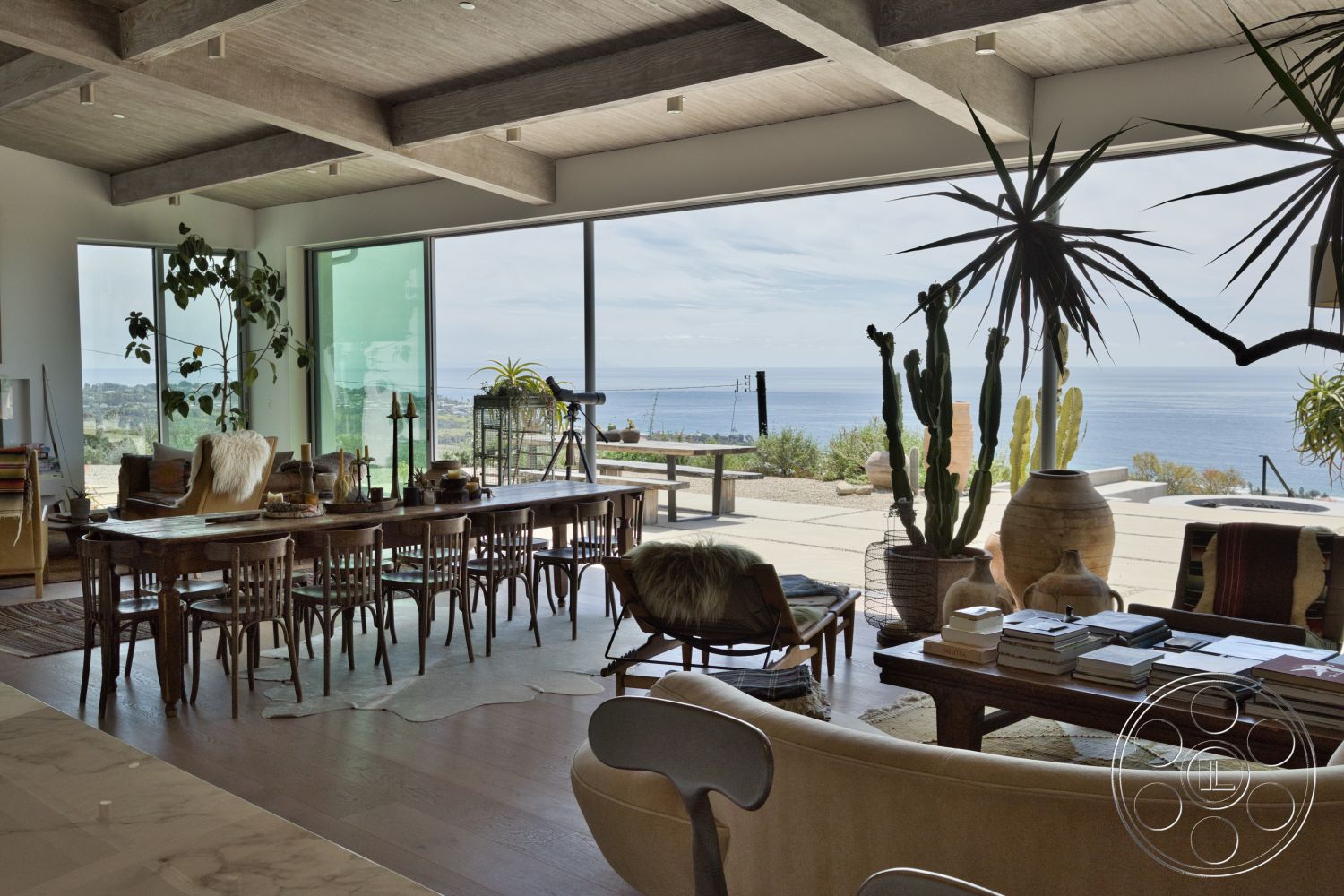 Modern 523 - neutral color palette, natural light, textured wall, open floor plan, plant accents, wood dining table, glass sliding doors, floor-to-ceiling windows, ocean view, distressed wood accents, scenic landscape, wood dining chairs, exposed wood ceiling beams, concrete patio flooring, modern coastal style