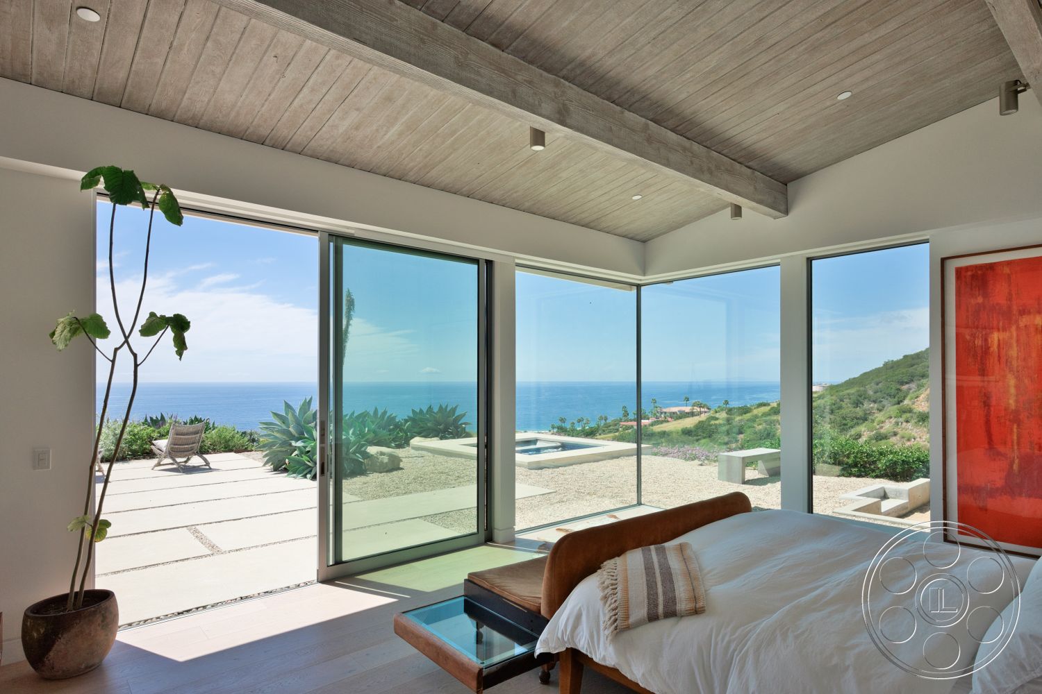 Modern 523 - minimalist decor, natural light, modern aesthetic, ocean view, succulent plants, floor-to-ceiling glass windows, concrete patio floor, king-size wooden bed frame, vaulted wood beam ceiling