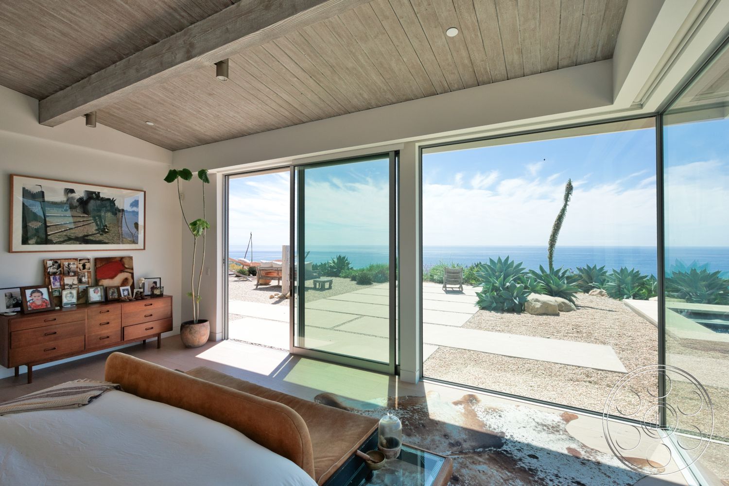 Modern 523 - large windows, natural light, exterior, minimalist design, indoor plants, open floor plan, wooden dresser, modern furniture, glass sliding doors, landscape view, concrete patio, decorative wall art, textured wall treatments, wood beam ceiling, desert home setting, spacious bedroom