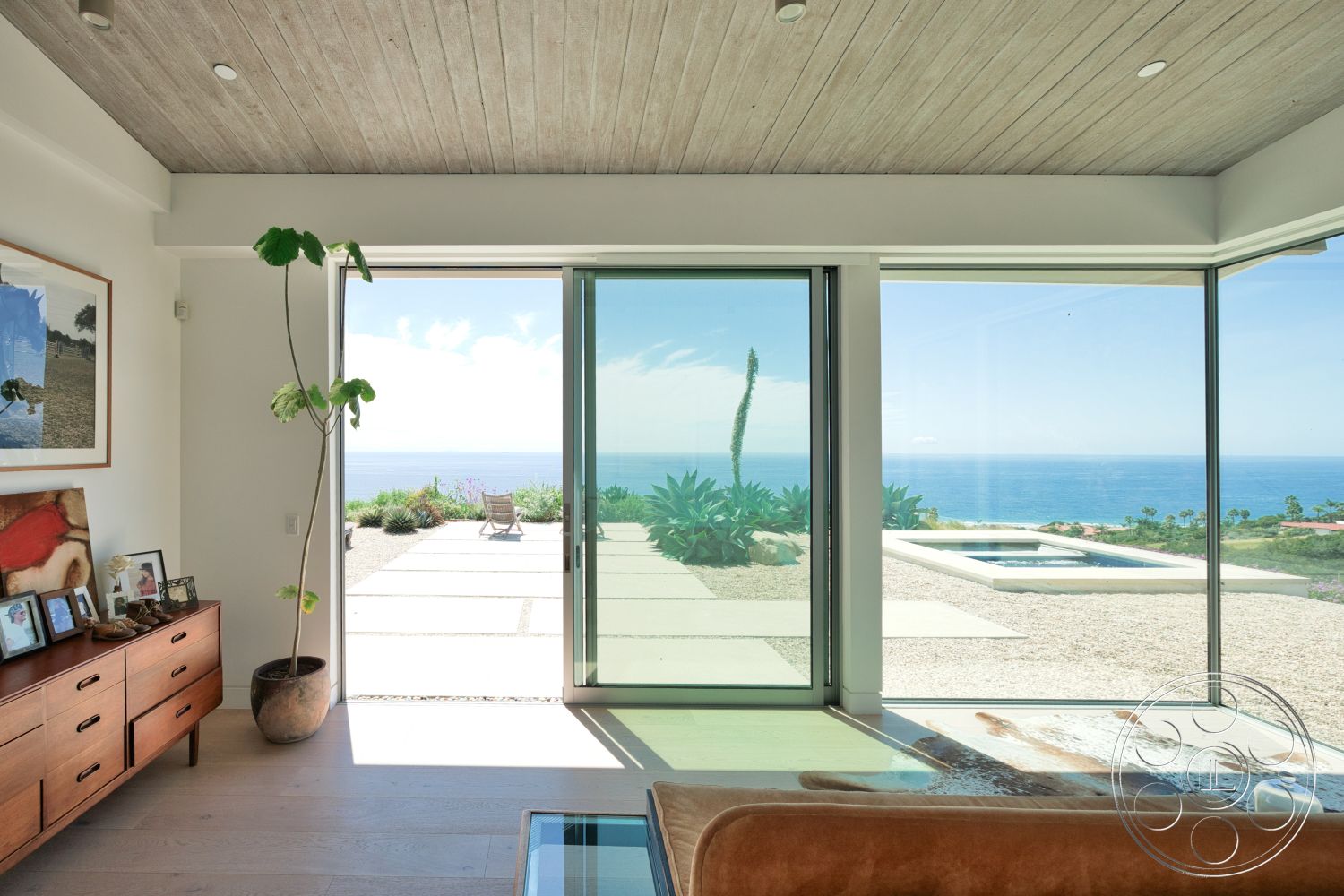 Modern 523 - minimalist decor, neutral color palette, landscaped garden, contemporary design, light hardwood flooring, modern furniture, wood panel ceiling, glass sliding doors, ocean view, exposed light fixtures, stone patio flooring, floating furniture arrangement