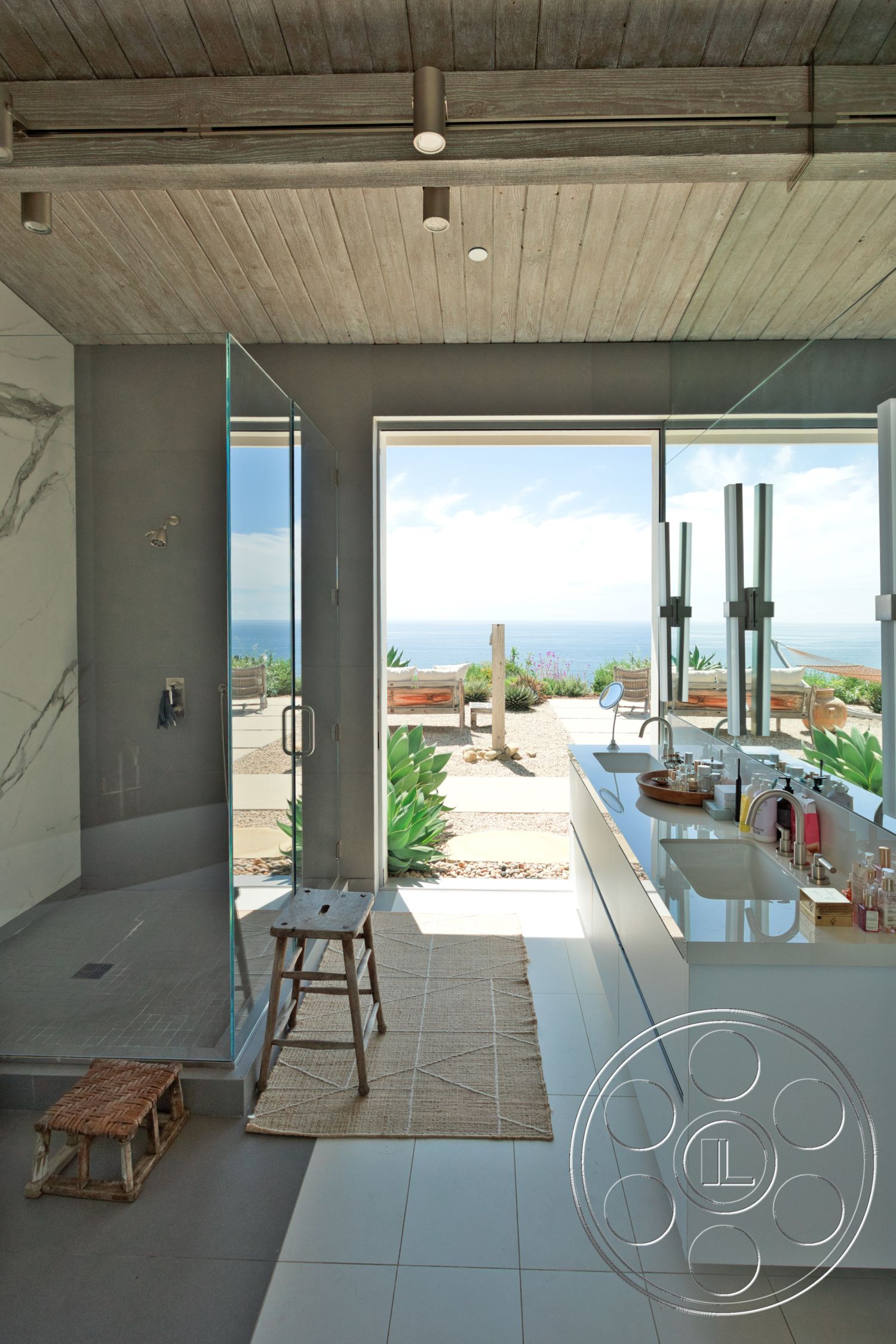 Modern 523 - exterior, minimalist design, white cabinetry, woven area rug, open-concept layout, large sliding glass doors, natural landscape view, glass shower doors, wood beam ceiling, tile bathroom flooring, marble bathroom wall, modern bathroom decor, concrete shower floor