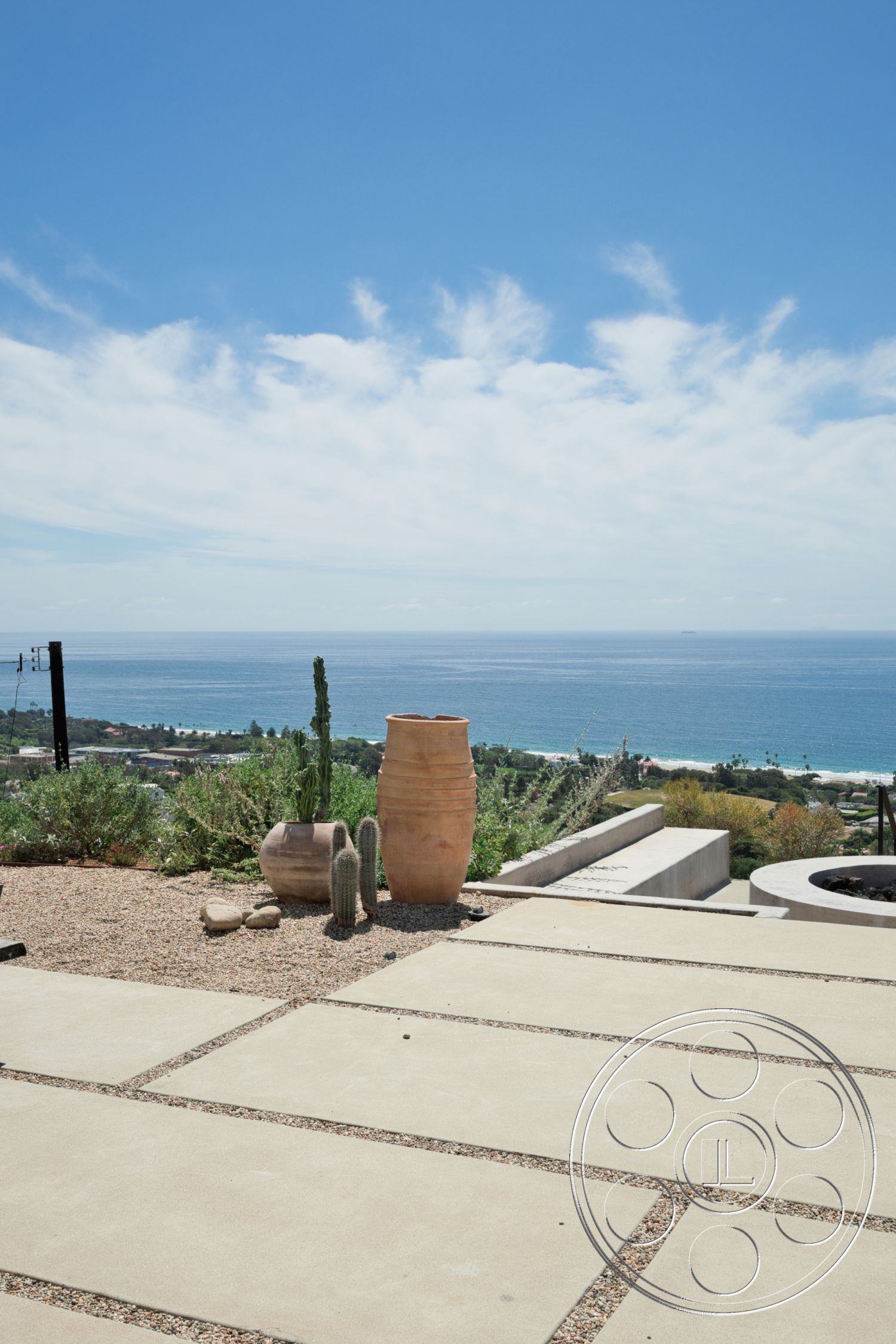 Modern 523 - exterior, natural stone accents, minimalist design, ocean view, desert landscaping, hillside location, cactus plants, concrete patio flooring, rectangular concrete pavers, large ceramic planters