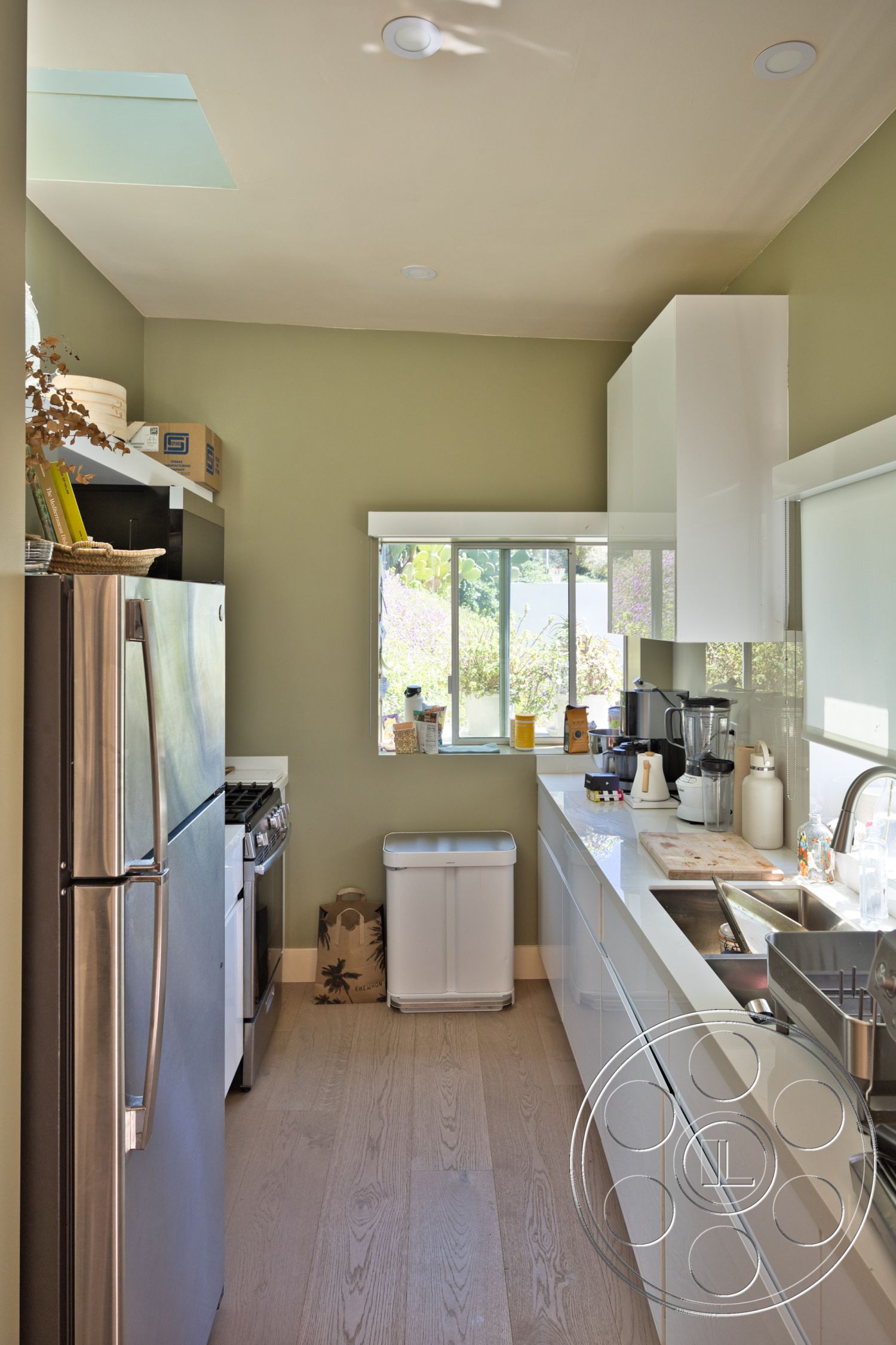 Modern 523 - stainless steel appliances, white cabinetry, green accent wall, sliding glass window, recessed ceiling lights, modern kitchen design, open kitchen layout, interior kitchen, undercabinet lighting, quartz kitchen countertop, wood plank flooring, minimalist kitchen style