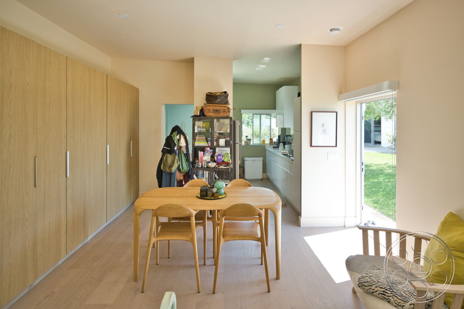 Modern 523 - natural light, modern design elements, light wood cabinetry, floor-to-ceiling windows, casual dining area, white countertops, light wood dining table, outdoor garden view, open kitchen layout, smooth wall finish, neutral painted walls, cozy living area, custom built-in storage, white kitchen cabinets, light wood dining chairs, fixed glass door