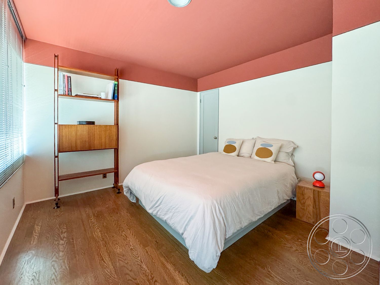 The Kun House - natural light, floor-to-ceiling windows, decorative table lamp, wood bedside table, hardwood bedroom floors, white painted walls, pink ceiling paint, mid-century modern shelving unit, minimalist bed frame, contemporary bed linens