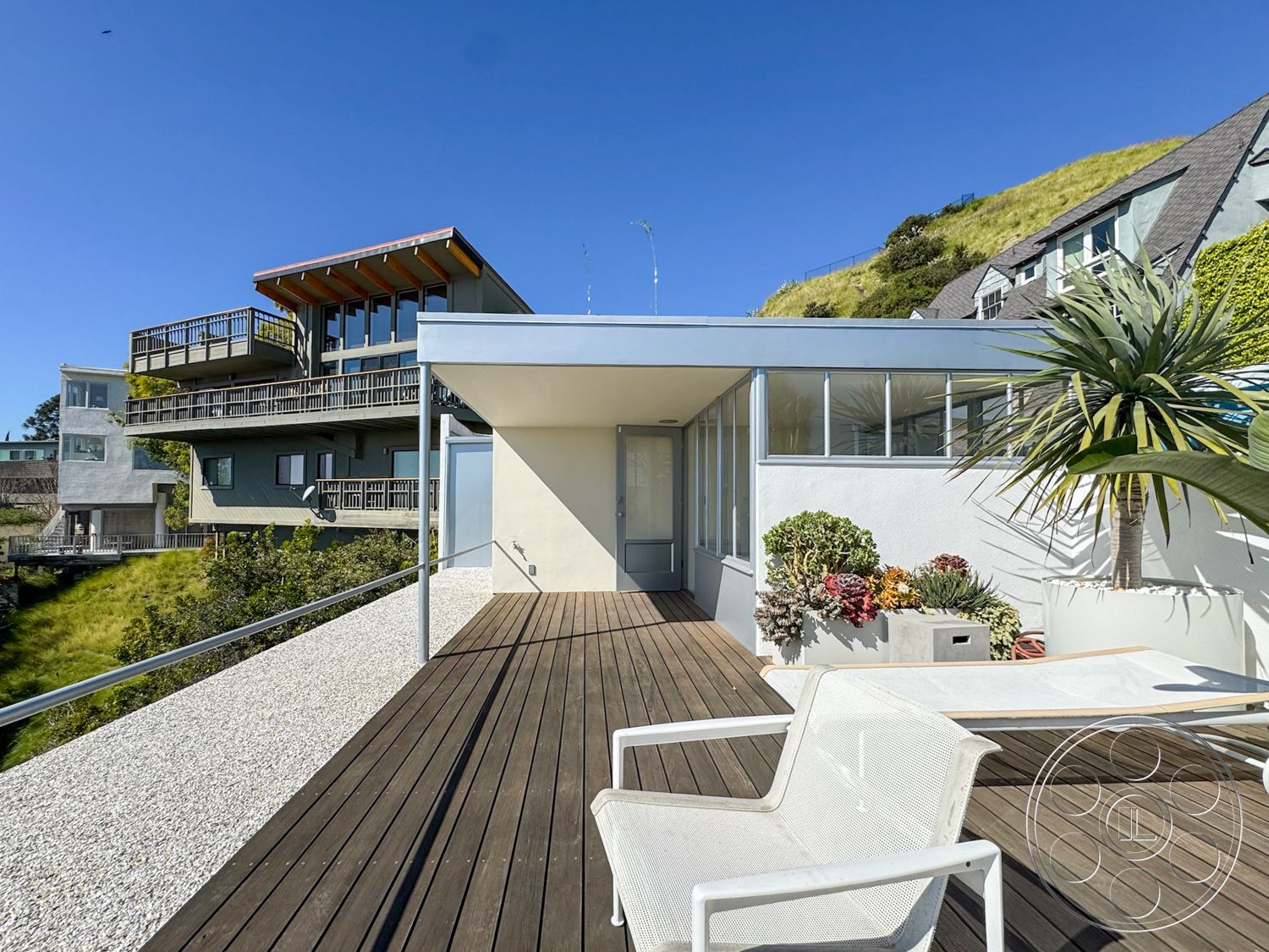 The Kun House - large windows, exterior, glass sliding doors, metal railing, landscaped hillside, multi-story house, flat roof design, contemporary architectural style, wood deck flooring, open patio layout, modern house facade, succulent garden planters