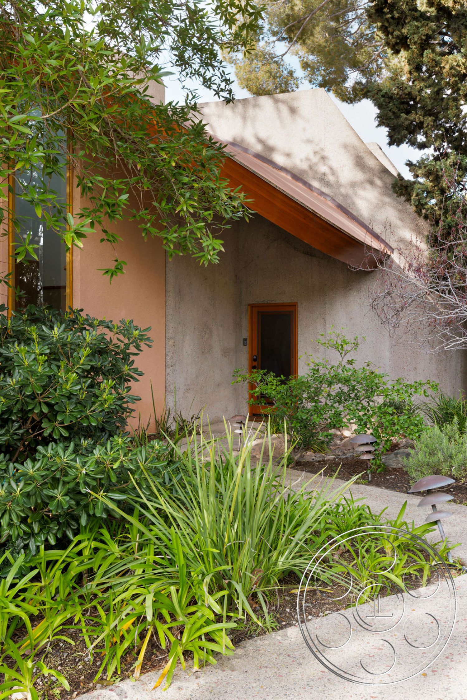 Mid-Century Exotic - exterior, landscaped garden, concrete pathway, modern architectural style, stucco walls, wooden front door, flat roof design, wooden roof overhang, decorative garden lighting, lush green plants