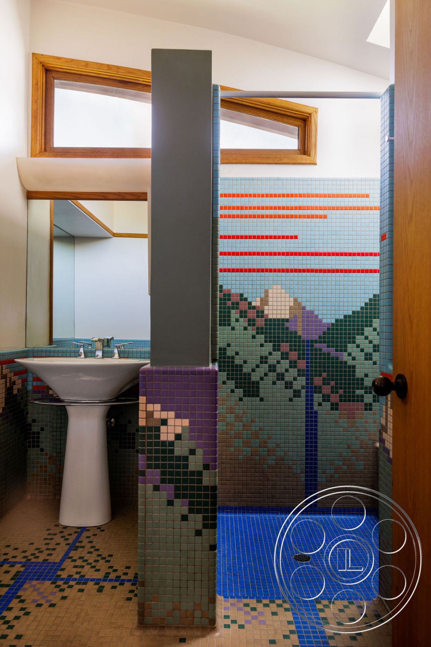 Mid-Century Exotic - wood cabinetry, textured plaster ceiling, wood-framed windows, colorful mosaic tile shower walls, blue mosaic tile shower floor, white porcelain bathroom sink, geometric mosaic wall pattern, stepped wall design, contrasting colored mosaic panels