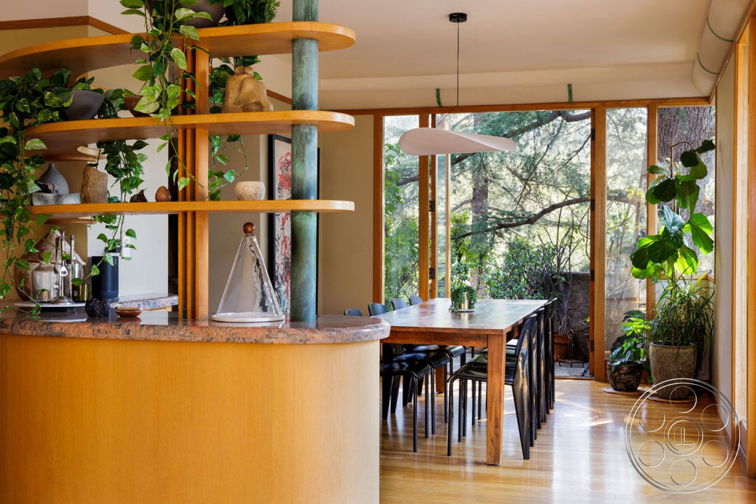 Mid-Century Exotic - neutral wall colors, indoor plants, large glass windows, wood dining table, exposed wood ceiling beams, minimalist pendant lighting, wooden bar countertop, wood paneling details, curved bar design, natural light-filled dining area, black leather dining chairs, granite bar surface, open shelving with wood shelves, green accent color