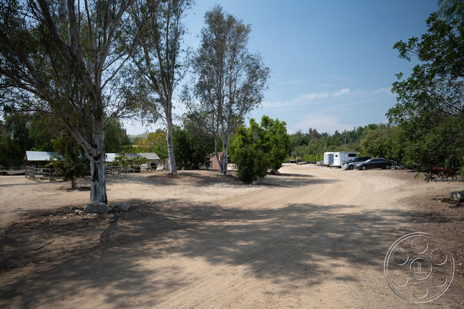 Ranch 6 - exterior, landscaped gardens, natural surroundings, open outdoor space, gravel path, dirt driveway, rural landscape, eucalyptus trees, flat terrain, outdoor parking area, agricultural setting, metal roof structures