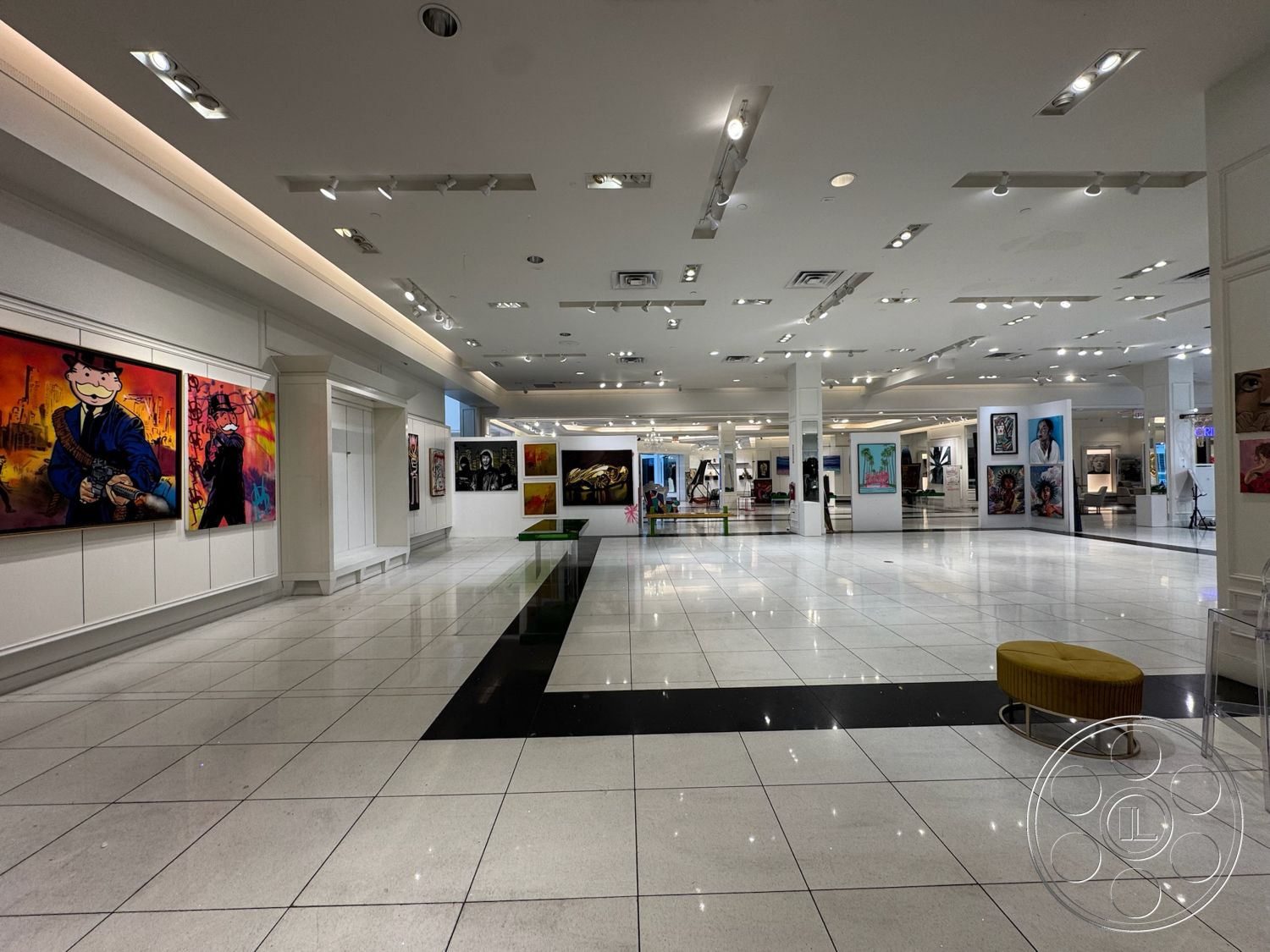 Beverly Gallery - minimalist design, open floor plan, art gallery space, polished marble flooring, modern seating area, white painted walls, circular accent chair, extensive track lighting, exhibition area, black and white floor pattern, large artwork displays