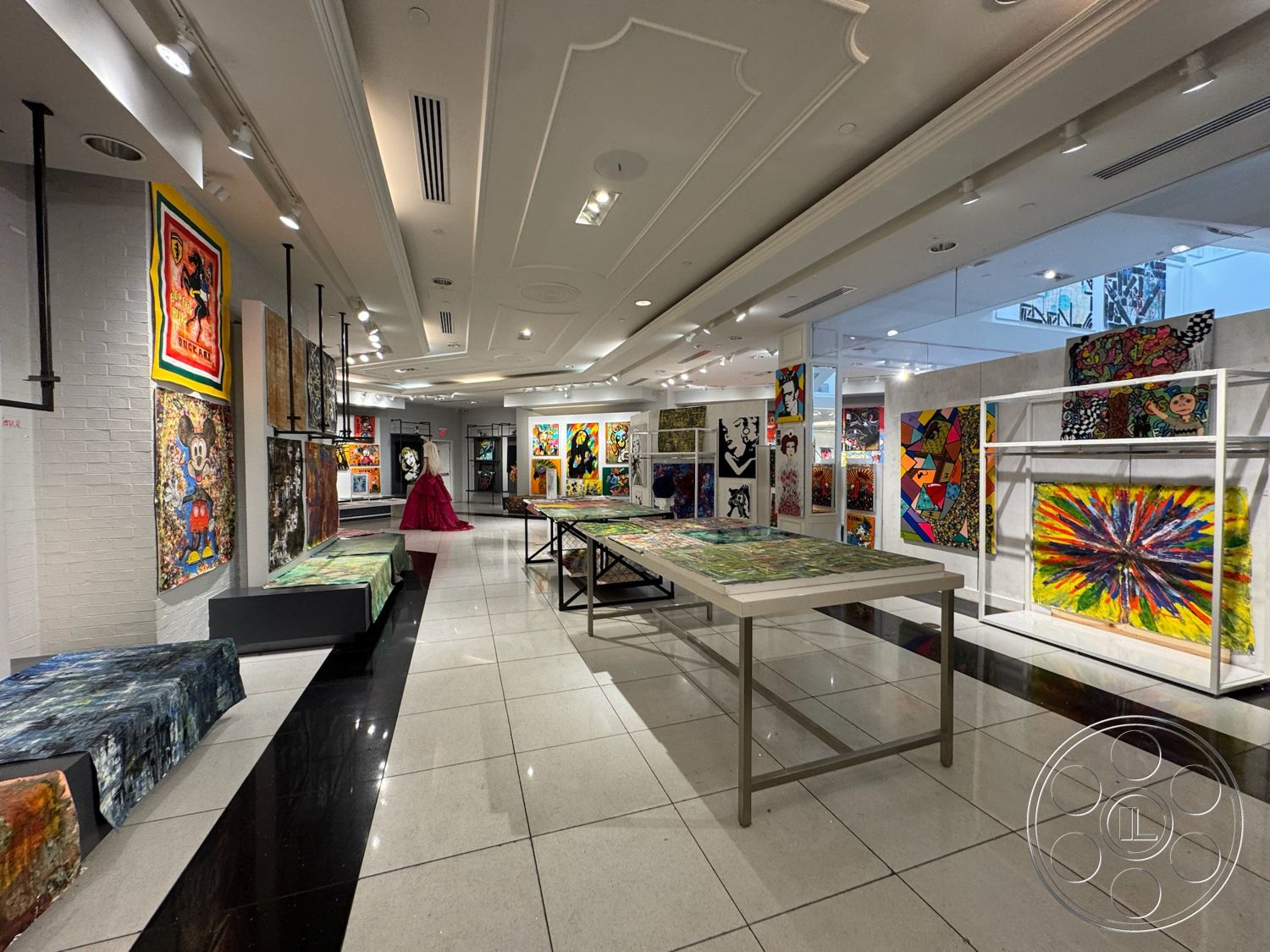 Beverly Gallery - track lighting, exhibition space, glossy tile flooring, white painted walls, coffered ceiling design, modern display tables, multicolored artwork installations, glass display panels, black and white tile accent