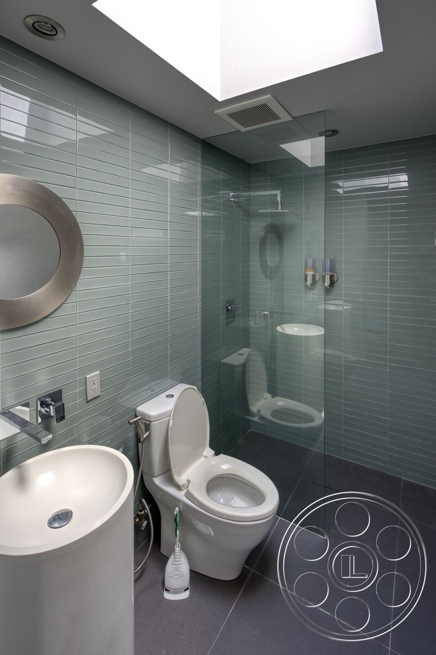 Modern 525 - glass shower enclosure, dark stone flooring, modern bathroom design, skylight ceiling, tile bathroom walls, contemporary toilet, circular wash basin